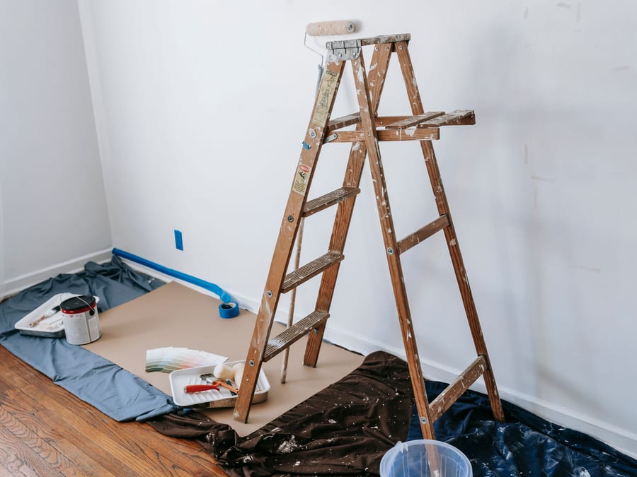 Protective covering laid smooth across a hardwood floor before any work begins.